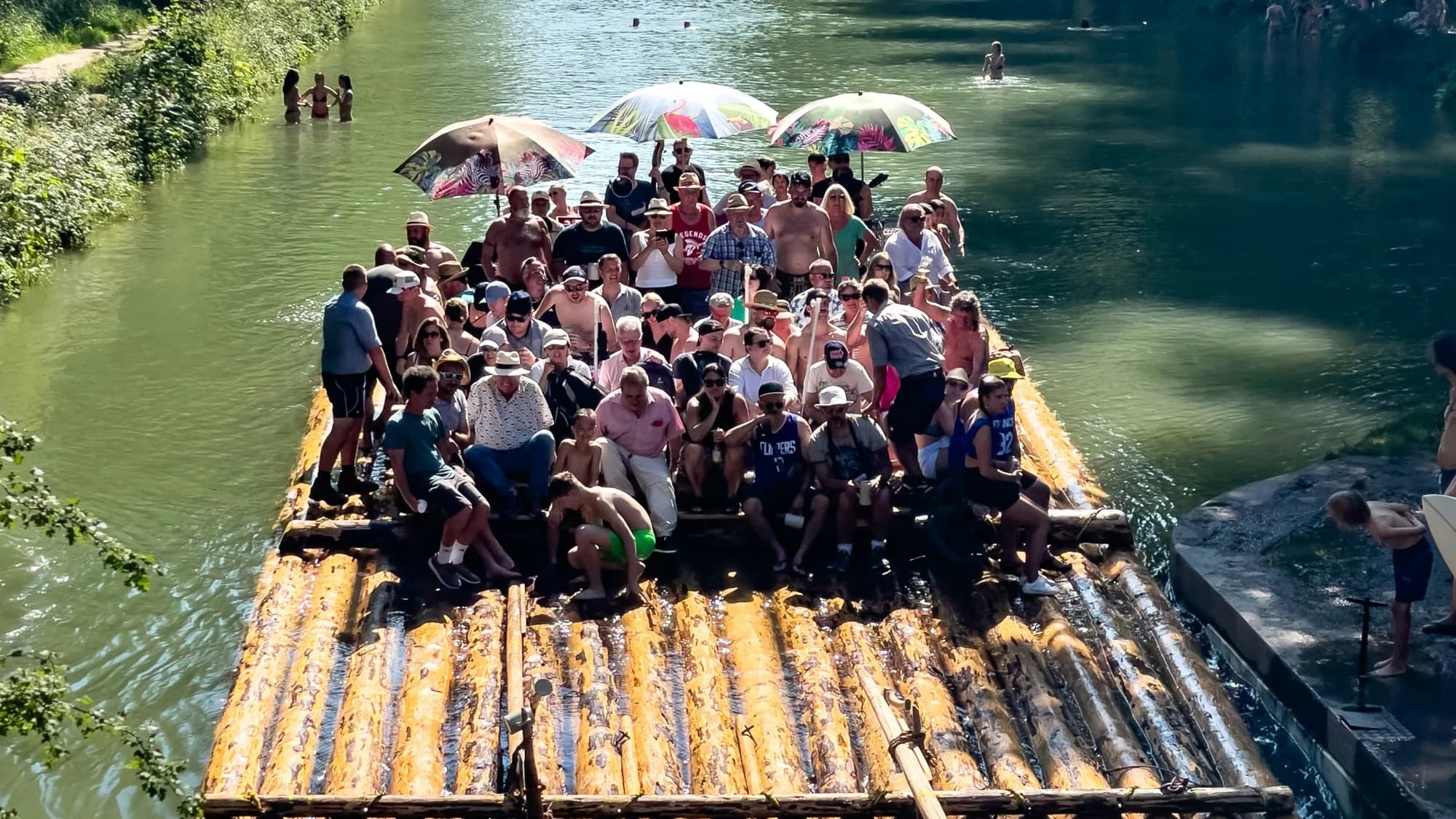 A group enjoying a summer raft gathering on Munich's Isar